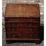 An 18th century walnut Bureau with pine sides, the interior with a well and fitted with small