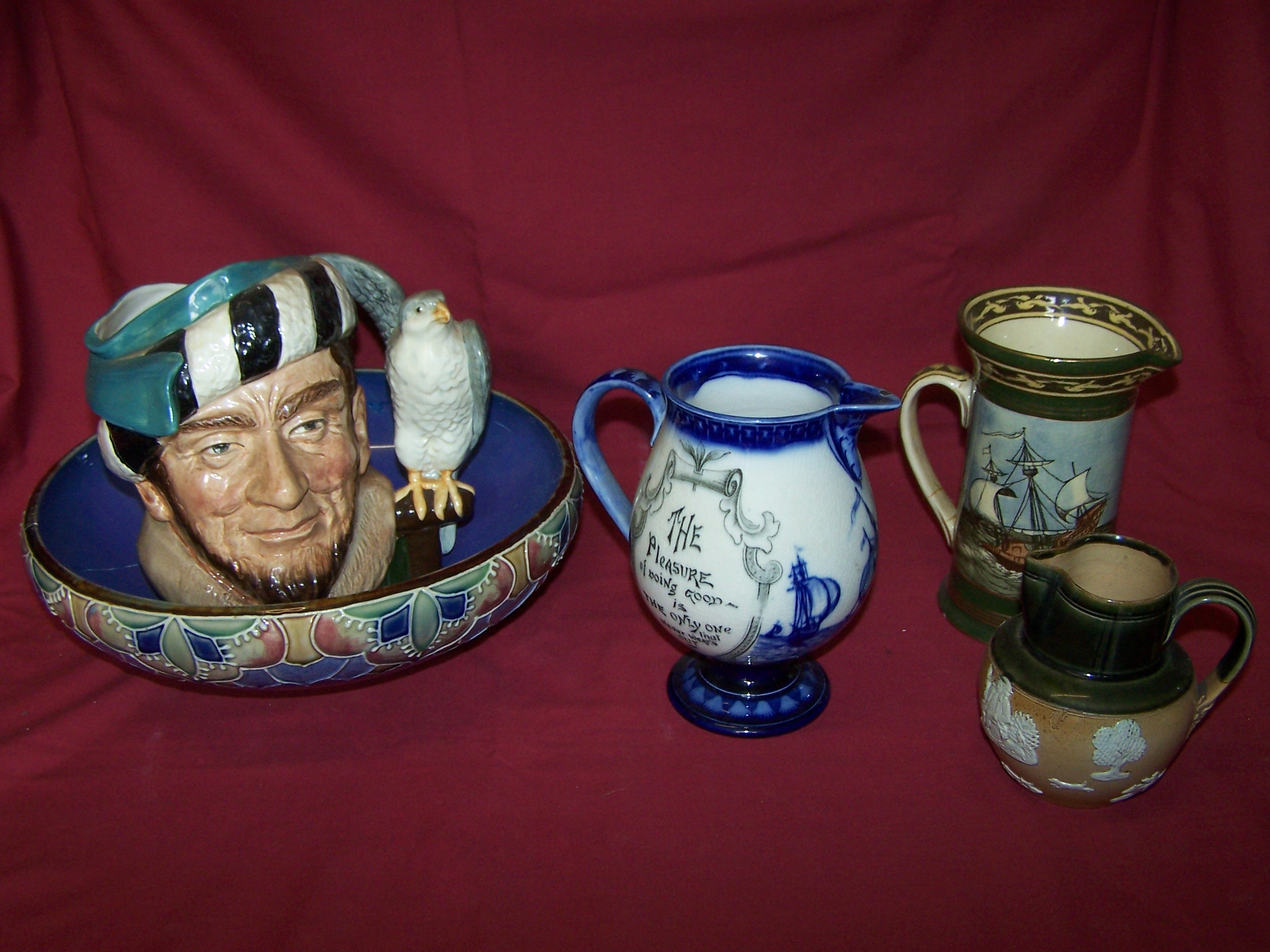 A Royal Doulton baluster Jug decorated with galleons, verse, etc., with loop handle and pedestal