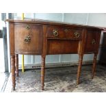 A Regency mahogany Sideboard of bowed outline, fitted with two centre drawers flanked by two