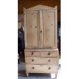 A Victorian pine Kitchen Press, the upper section enclosed by a pair of panelled doors, two long and