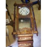 A late 19th century American Wall Clock with white dial in simulated rosewood case, inlaid with