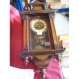 A late 19th century Vienna Wall Clock with ivoreen dial, in inlaid architectural style case with