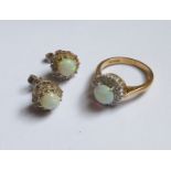 An 18ct. gold Cluster Ring set with an opal surrounded by diamonds and a pair of stud earrings to