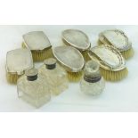 Three pairs of silver backed Brushes, a pair of cut glass Dressing Table Bottles with silver