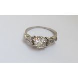 A white metal Solitaire Diamond Ring with central old European cut diamond, the shoulders set with
