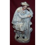 A large Staffordshire flat backed Figure of a highlander leaning on a tree trunk, 14" (36cms) high.