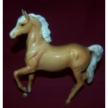 A Beswick model of a Palomino Horse, model 1261, 1st version.  (ear repaired).