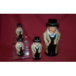 A Royal Doulton Character Jug "Winston Churchill", 9" (23cms) high; a smaller Winston Churchill Jug,