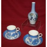 A pair of Royal Worcester Coffee Cups and Saucers decorated in blue and white, and a Royal