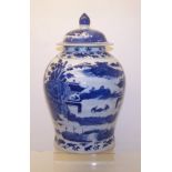 A late 19th century Chinese baluster Vase and Cover decorated in blue and white with the 'figures on