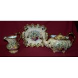 A Hammersley Teapot of oval design decorated with autumn fruits, and a matching Jug and Serving