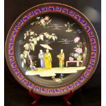 An A E Gray & Co earthenware Charger decorated with oriental figures, flowers and trees on a black
