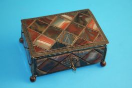 A small agate and metalware casket, the top, sides and base inset with brightly coloured agates