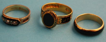 A Victorian 18ct gold mourning ring, another 18ct band and a 9ct gold pearl set mourning ring.