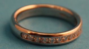 An 18ct white gold diamond half hoop ring, ring size I/J.