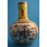 A Chinese yellow ground bottle shaped vase with two panels of scrolls, vases and foliage, marks in