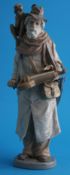 A Lladro figure of a Street Musician, the old man wearing a hat with a monkey on his shoulder,