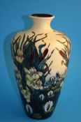 A modern Moorcroft vase of tapering form on a pale yellow ground decorated with water lilies and