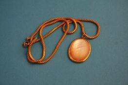 A gold coloured chain with mother of pearl pendant.