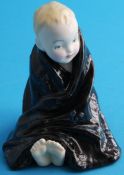 A figure 'Baby' with black blanket, colour variation (not produced for sale).