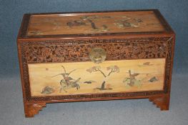 An Oriental camphorwood chest, the top and sides decorated in jade with inlaid decoration of