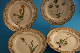 A set of four Royal Copenhagen "Flora Danica" plates, each decorated with named botanical specimen