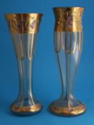 Two Bohemian decorative glass vases each decorated with blue bells and highlighted in gilt on a
