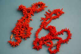 Three strands of orange coral necklaces.