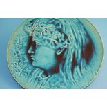 A Burmantofts Faience circular charger by P Mallet dated 1886, in low relief with a portrait of a