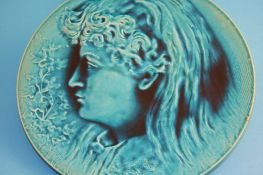 A Burmantofts Faience circular charger by P Mallet dated 1886, in low relief with a portrait of a