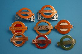 A collection of eight London Transport cap badges, various.