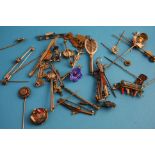 A collection of 16 assorted metal stick pins, including a 9ct gold horse shoe pin and 20 various