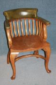 A set of four 1930's oak office chairs with green leather backs and arms, with solid seat and