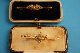 Two Victorian bar brooches, one 15ct set with aquamarine and seed pearl and a 9ct seed pearl set