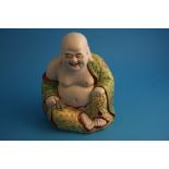 A Chinese model of a seated Buddha.25 cm high