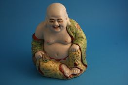A Chinese model of a seated Buddha.25 cm high