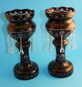 A pair of ruby coloured lustres.37 cm high