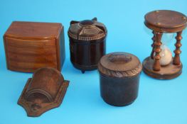 Two Bakelite tobacco jars; a large treen egg timer; a treen wall pocket; and an Art Deco style chest