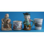 A pottery 'Punch and Judy' jug, a model of 'Tom Piper', a beaker inscribed 'Landing Stage Pavilion