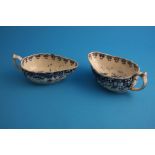 A pair of late 18th century blue and white sauce boats decorated in the Oriental manner.15.5 cm