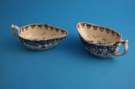 A pair of late 18th century blue and white sauce boats decorated in the Oriental manner.15.5 cm