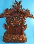 A large Black Forest stained pine and carved cuckoo bracket clock (in need of restoration).71 cm