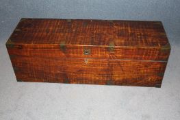 A large mahogany Campaign trunk with brass bands and two carrying handles to the sides.130 cm long