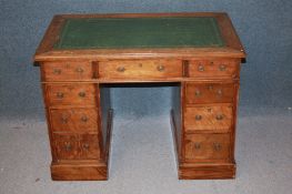 A late 19th / early 20th century mahogany child's pedestal desk with inset top below nine drawers