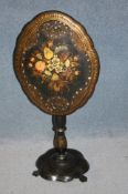A Victorian papier mache tilt top occasional table, the top painted and inlaid with mother of