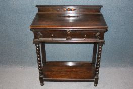 A small oak side table with single drawer below barley twist legs and plain undertier supported on