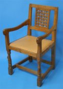A set of 8 Robert "Mouseman" Thompson oak dining chairs with lattice work backs each with carved