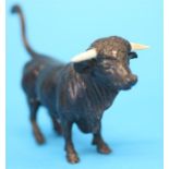 A small Austrian bronze bull, circa 1890, with ivory horns.  12 cm long