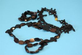 A jet coloured choker, a necklace and a bracelet. (3)