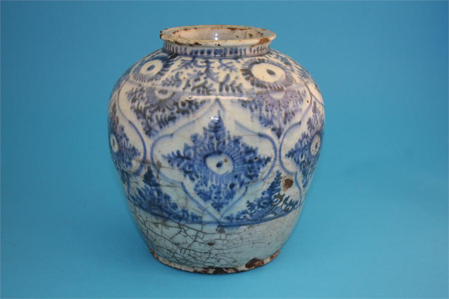 An 18th/19th century Islamic tinglazed earthenware blue and white globular shaped vase decorated